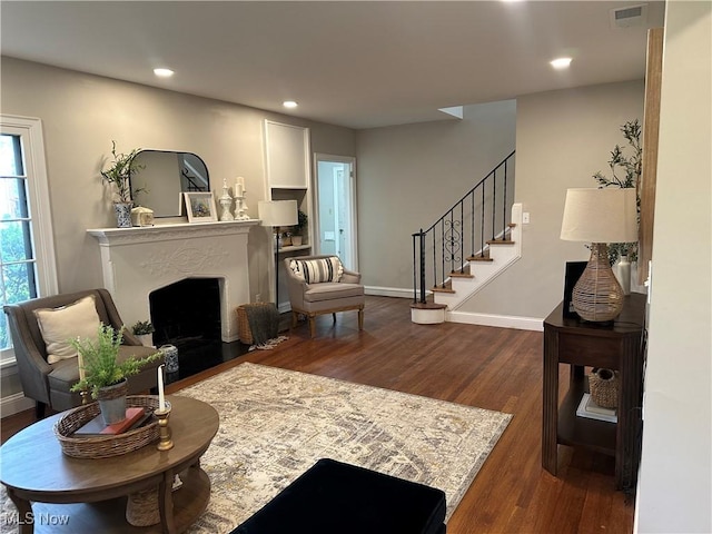 13707 Drexmore Rd, Shaker Heights, OH 44120 - living room featuring wood finished floors, a fireplace, stairs, recessed lighting, and baseboards