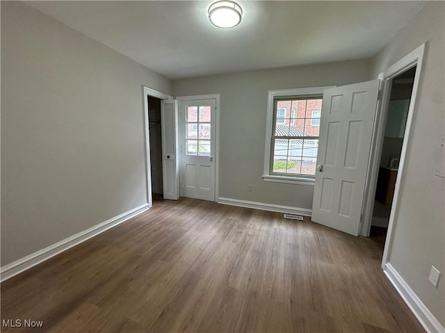 13707 Drexmore Rd, Shaker Heights, OH 44120 - unfurnished bedroom with dark wood-style floors and baseboards
