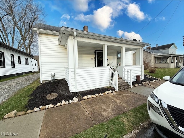 1324 N 4th St, Toronto, OH 43964 - view of front of property with covered porch and a chimney
