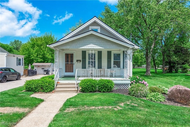 163 E Martin St, Amherst, OH 44001 - bungalow-style home featuring covered porch and a front yard