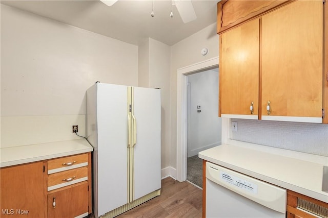 163 E Martin St, Amherst, OH 44001 - kitchen with white appliances, light wood-type flooring, light countertops, and a ceiling fan