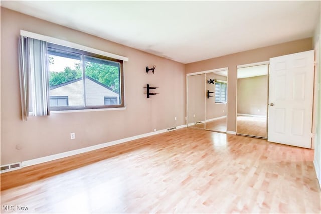 4473 Habersham Ln S, Richmond Heights, OH 44143 - unfurnished bedroom with two closets, light wood-style flooring, and baseboards