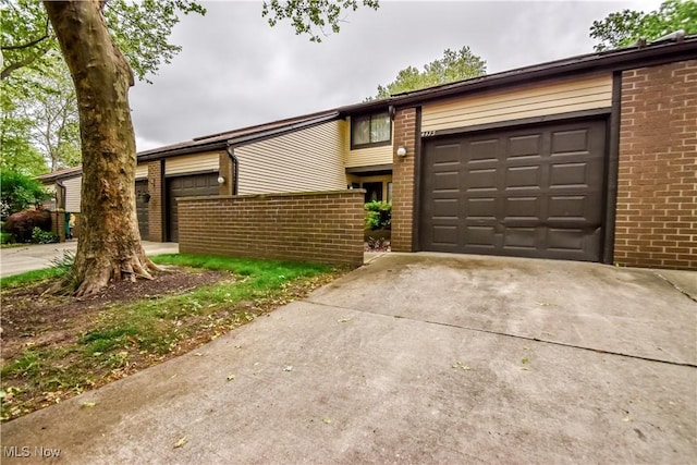 4473 Habersham Ln S, Richmond Heights, OH 44143 - mid-century home featuring brick siding, concrete driveway, and a garage