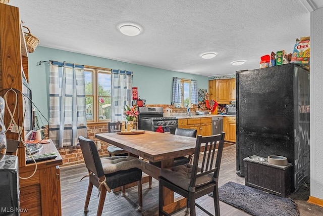 5869 Beechwood Ave, Alliance, OH 44601 - dining room featuring a textured ceiling and wood finished floors