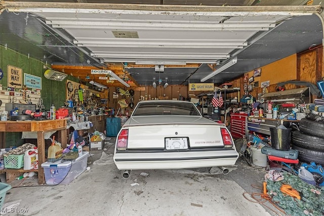 5869 Beechwood Ave, Alliance, OH 44601 - garage featuring a workshop area and a garage door opener