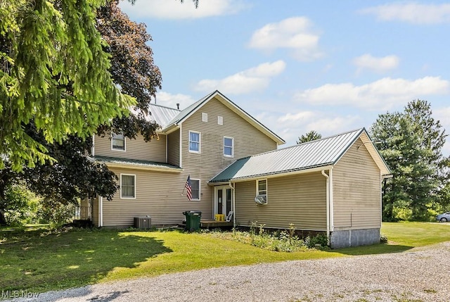 5869 Beechwood Ave, Alliance, OH 44601 - back of house with metal roof, a yard, and central AC