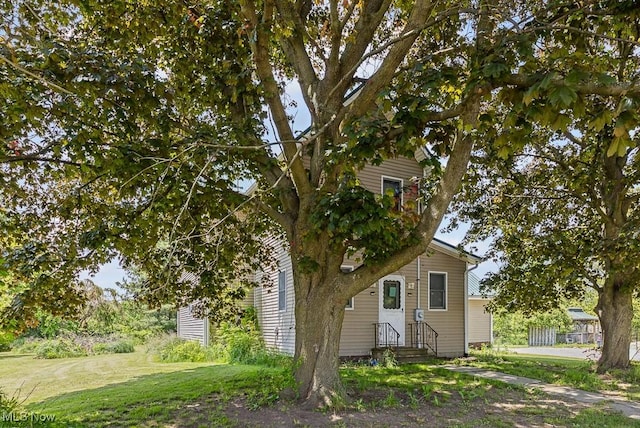 5869 Beechwood Ave, Alliance, OH 44601 - view of property hidden behind natural elements featuring a front lawn