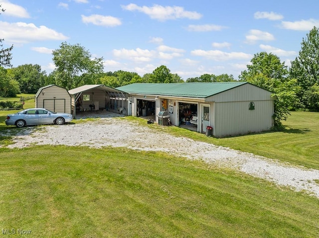 5869 Beechwood Ave, Alliance, OH 44601 - view of front of property featuring a garage, a front lawn, an outbuilding, and a pole building
