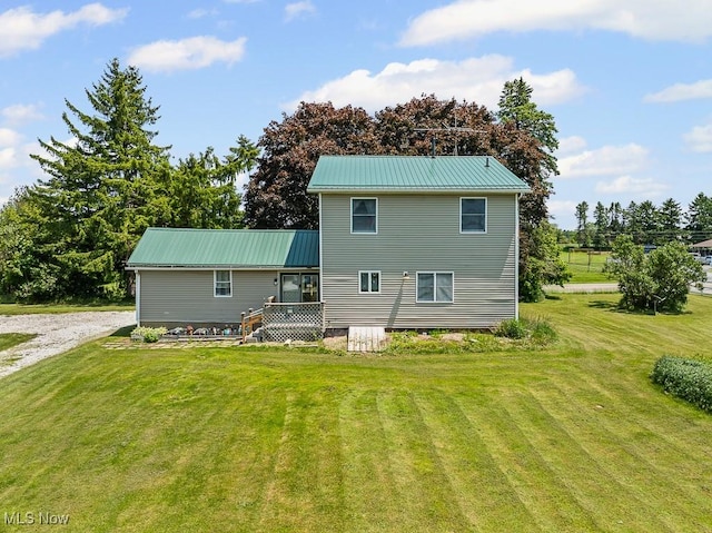 5869 Beechwood Ave, Alliance, OH 44601 - back of property with a yard, a deck, and metal roof