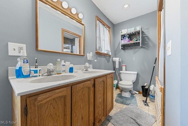 5869 Beechwood Ave, Alliance, OH 44601 - bathroom with double vanity, toilet, and tile patterned flooring