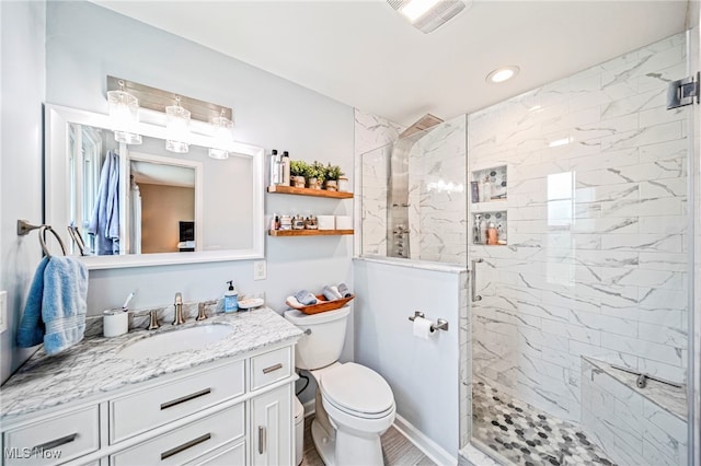 134 E 197th St, Euclid, OH 44119 - bathroom with a tile shower, vanity, toilet, and recessed lighting