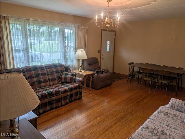 115 SW Spring St, Gnadenhutten, OH 44629 - living room featuring wood finished floors and a chandelier