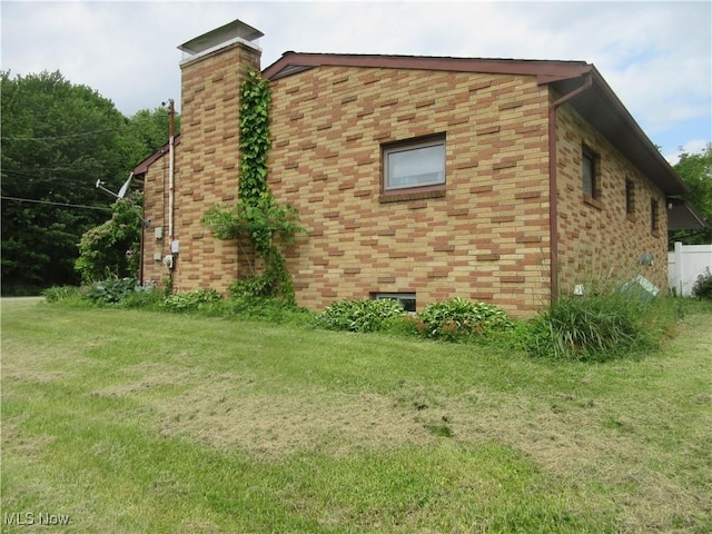 163 N Chestnut St, Linesville, PA 16424 - view of property exterior featuring a lawn and a chimney