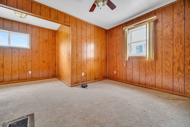 1586 E 86th St, Cleveland, OH 44106 - carpeted spare room featuring a ceiling fan, baseboards, and wood walls