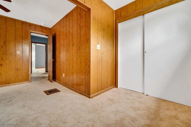 1586 E 86th St, Cleveland, OH 44106 - unfurnished room with carpet floors, a ceiling fan, and wooden walls