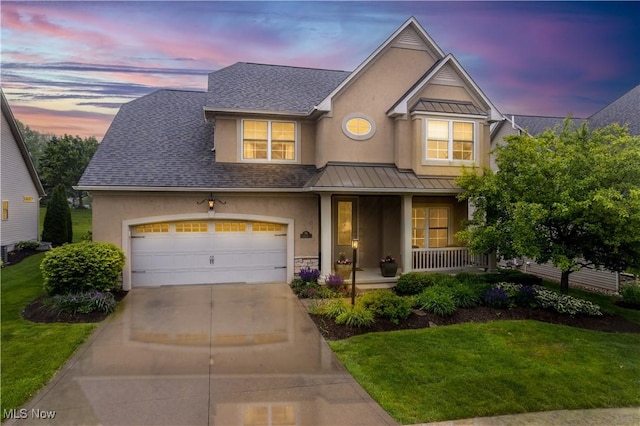 6047 Meadow Lake Dr, Medina, OH 44256 - traditional-style home with a porch, stucco siding, a standing seam roof, driveway, and a front yard