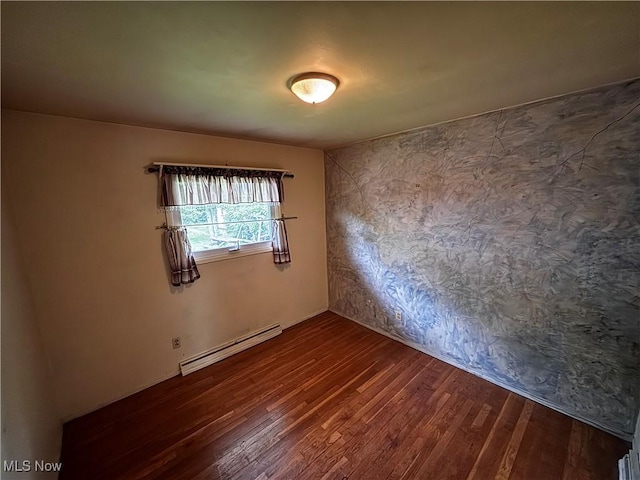 2325 Stewart Dr NW, Warren, OH 44485 - unfurnished room with a baseboard radiator and dark wood-type flooring