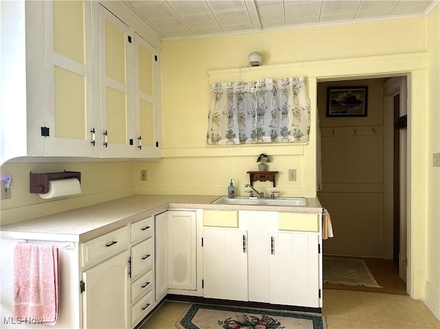 611 Forest St NE, Warren, OH 44483 - kitchen featuring a sink, light countertops, crown molding, and white cabinetry
