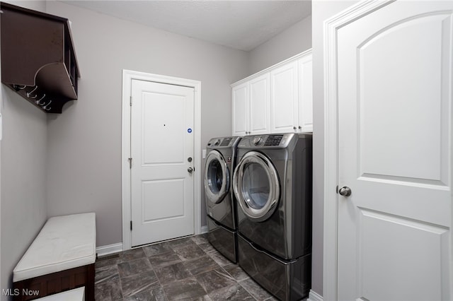 3413 Stillwood Blvd, Stow, OH 44224 - laundry area featuring washer and dryer, cabinet space, and baseboards