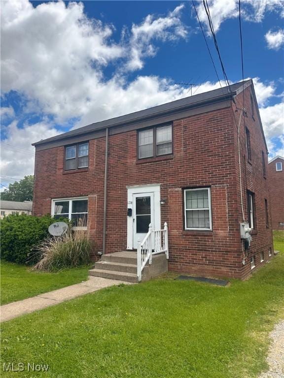 1736 Spring Ave NE, Canton, OH 44714 - view of front facade featuring brick siding and a front lawn