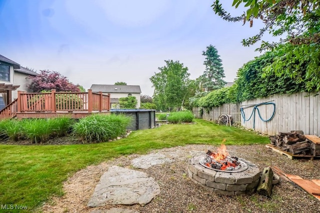 2410 Rohrer St NW, North Canton, OH 44720 - view of yard featuring an outdoor fire pit, a deck, and a swimming pool