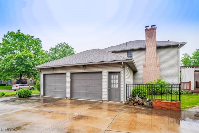 2410 Rohrer St NW, North Canton, OH 44720 - view of home's exterior featuring driveway, a chimney, a shingled roof, and a garage