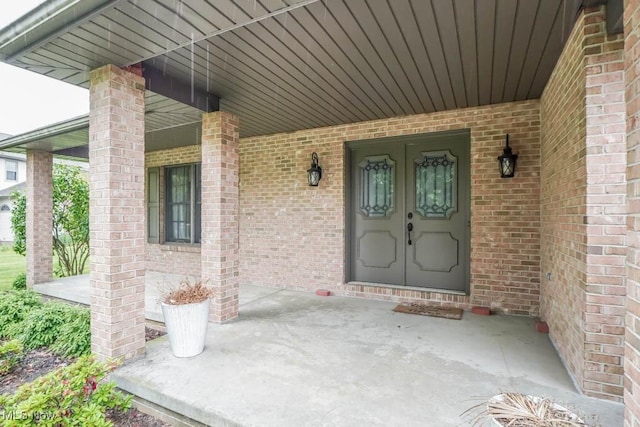 2410 Rohrer St NW, North Canton, OH 44720 - view of exterior entry with a porch and brick siding
