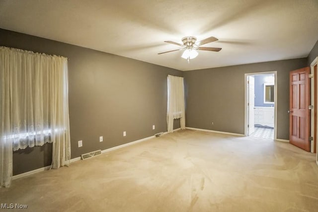 2410 Rohrer St NW, North Canton, OH 44720 - empty room featuring a ceiling fan, baseboards, and light carpet