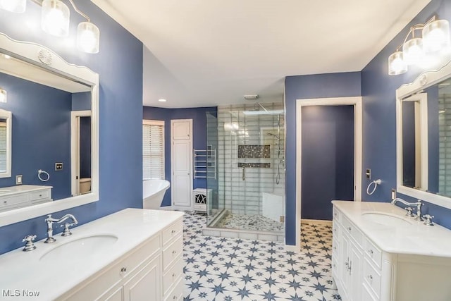2410 Rohrer St NW, North Canton, OH 44720 - bathroom featuring a stall shower, tile patterned floors, two vanities, and a soaking tub