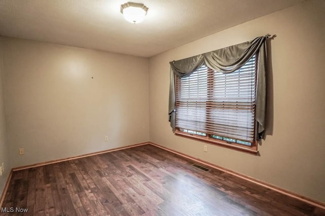 2410 Rohrer St NW, North Canton, OH 44720 - empty room featuring wood finished floors and baseboards