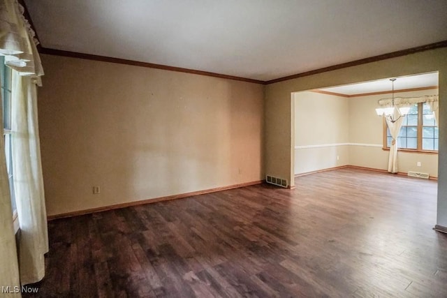 2410 Rohrer St NW, North Canton, OH 44720 - unfurnished room with wood finished floors, a chandelier, baseboards, and crown molding