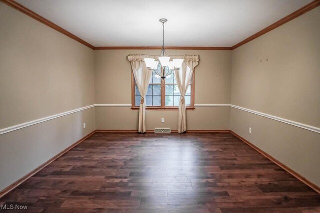 2410 Rohrer St NW, North Canton, OH 44720 - empty room featuring a chandelier, wood finished floors, baseboards, and ornamental molding