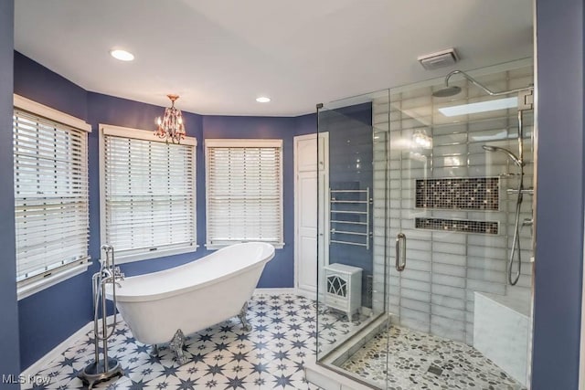 2410 Rohrer St NW, North Canton, OH 44720 - full bath featuring baseboards, a soaking tub, a shower stall, a chandelier, and recessed lighting