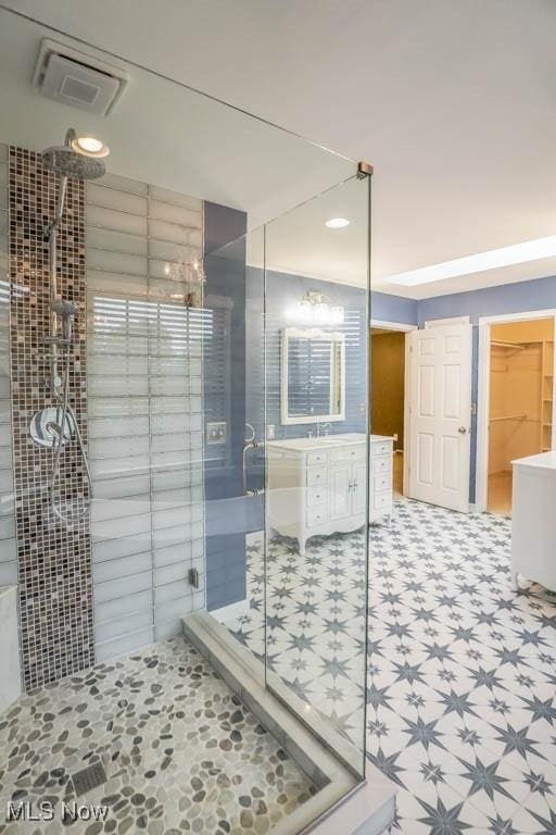 2410 Rohrer St NW, North Canton, OH 44720 - full bathroom with a stall shower, vanity, tile patterned floors, and a spacious closet