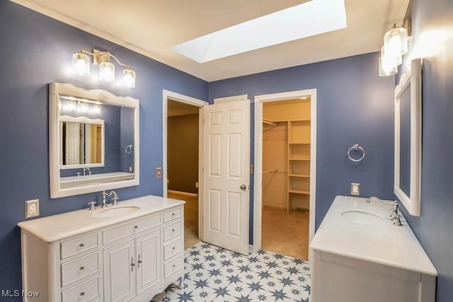 2410 Rohrer St NW, North Canton, OH 44720 - full bath with a skylight, tile patterned floors, two vanities, and a walk in closet