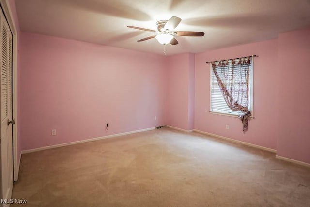 2410 Rohrer St NW, North Canton, OH 44720 - empty room featuring light carpet, a ceiling fan, and baseboards