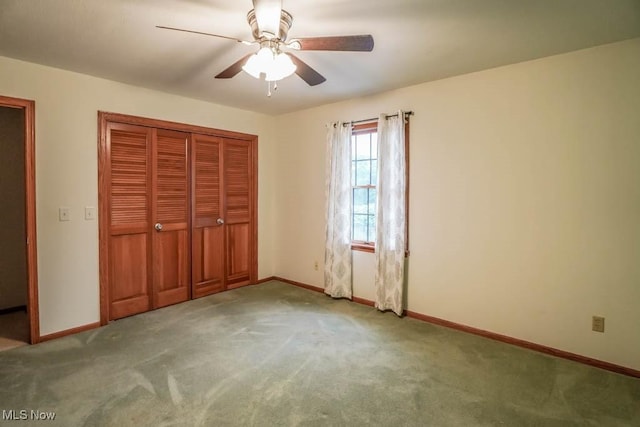 2410 Rohrer St NW, North Canton, OH 44720 - unfurnished bedroom featuring carpet, baseboards, a closet, and ceiling fan