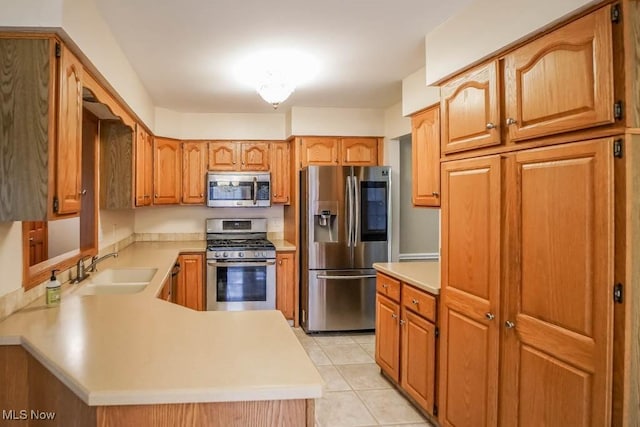 2410 Rohrer St NW, North Canton, OH 44720 - kitchen featuring appliances with stainless steel finishes, a sink, and light countertops