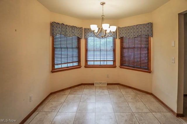 2410 Rohrer St NW, North Canton, OH 44720 - unfurnished dining area featuring a chandelier, baseboards, and light tile patterned floors