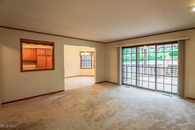 2410 Rohrer St NW, North Canton, OH 44720 - spare room with a chandelier, light colored carpet, crown molding, and baseboards