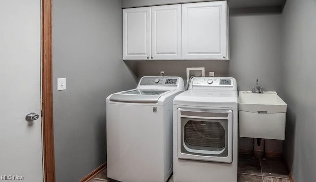 2410 Rohrer St NW, North Canton, OH 44720 - washroom with cabinet space, separate washer and dryer, and baseboards