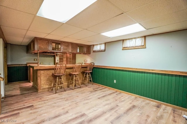 2410 Rohrer St NW, North Canton, OH 44720 - indoor bar featuring a wainscoted wall, wood finished floors, and a paneled ceiling