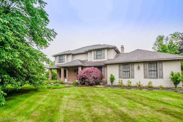 2410 Rohrer St NW, North Canton, OH 44720 - view of front facade featuring a chimney and a front yard