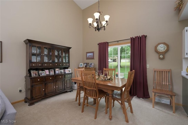 1441 Shaw Ave Unit A, Niles, OH 44446 - dining space featuring high vaulted ceiling, a chandelier, light colored carpet, and baseboards