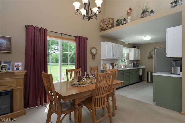 1441 Shaw Ave Unit A, Niles, OH 44446 - dining area featuring a chandelier, light carpet, and a glass covered fireplace