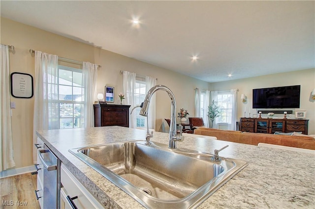 1572 Gate House St NE, Canton, OH 44721 - kitchen with a sink, open floor plan, white cabinets, light countertops, and light wood-type flooring