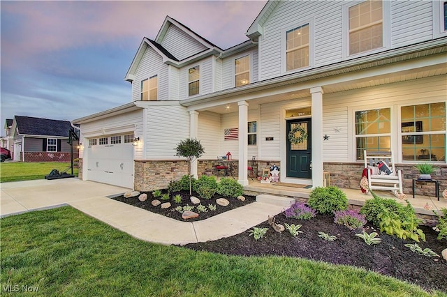 1572 Gate House St NE, Canton, OH 44721 - view of front facade with covered porch, driveway, stone siding, and a front yard