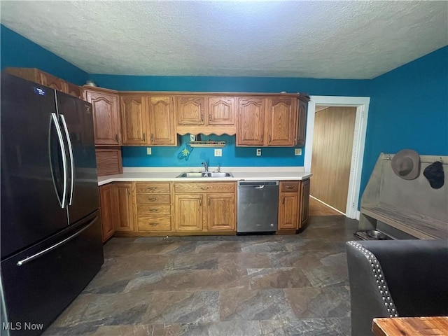 2743 Cow Creek Rd, Saint Marys, WV 26170 - kitchen featuring freestanding refrigerator, dishwasher, a sink, a textured ceiling, and light countertops