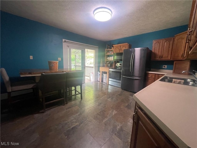 2743 Cow Creek Rd, Saint Marys, WV 26170 - kitchen featuring appliances with stainless steel finishes, a sink, a textured ceiling, an office area, and brown cabinets