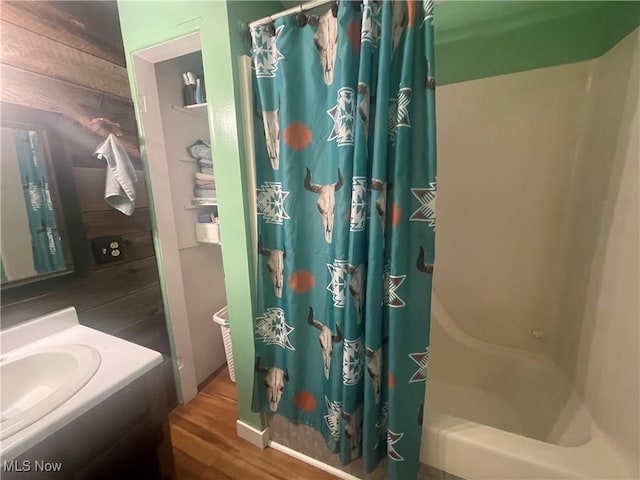 2743 Cow Creek Rd, Saint Marys, WV 26170 - bathroom featuring vanity, wood finished floors, and shower / bath combo with shower curtain